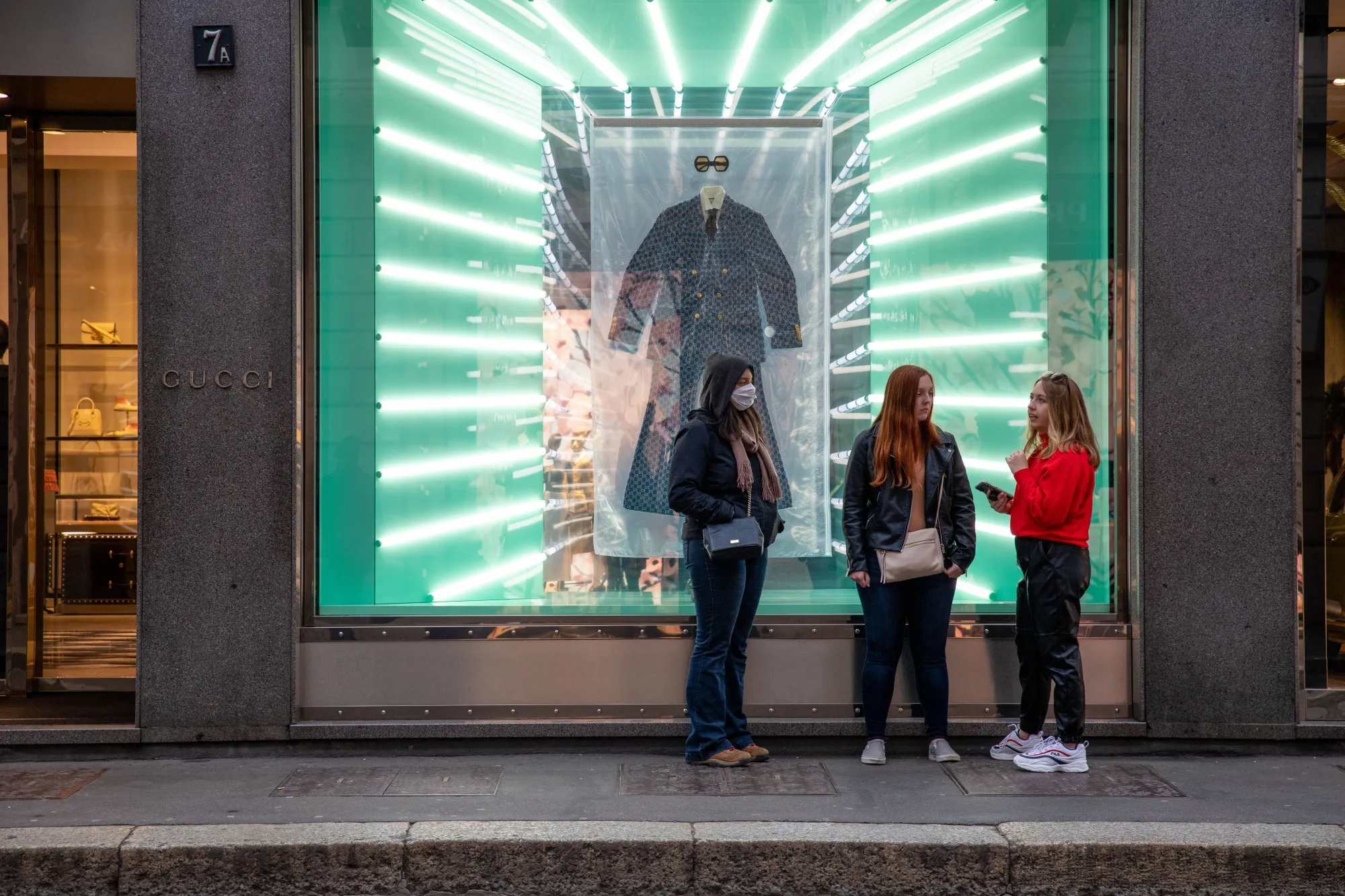 A pedestrian wearing a protective face mask stands outside the Gucci store in Milan, Italy, on&nbsp;Feb. 25.&nbsp;