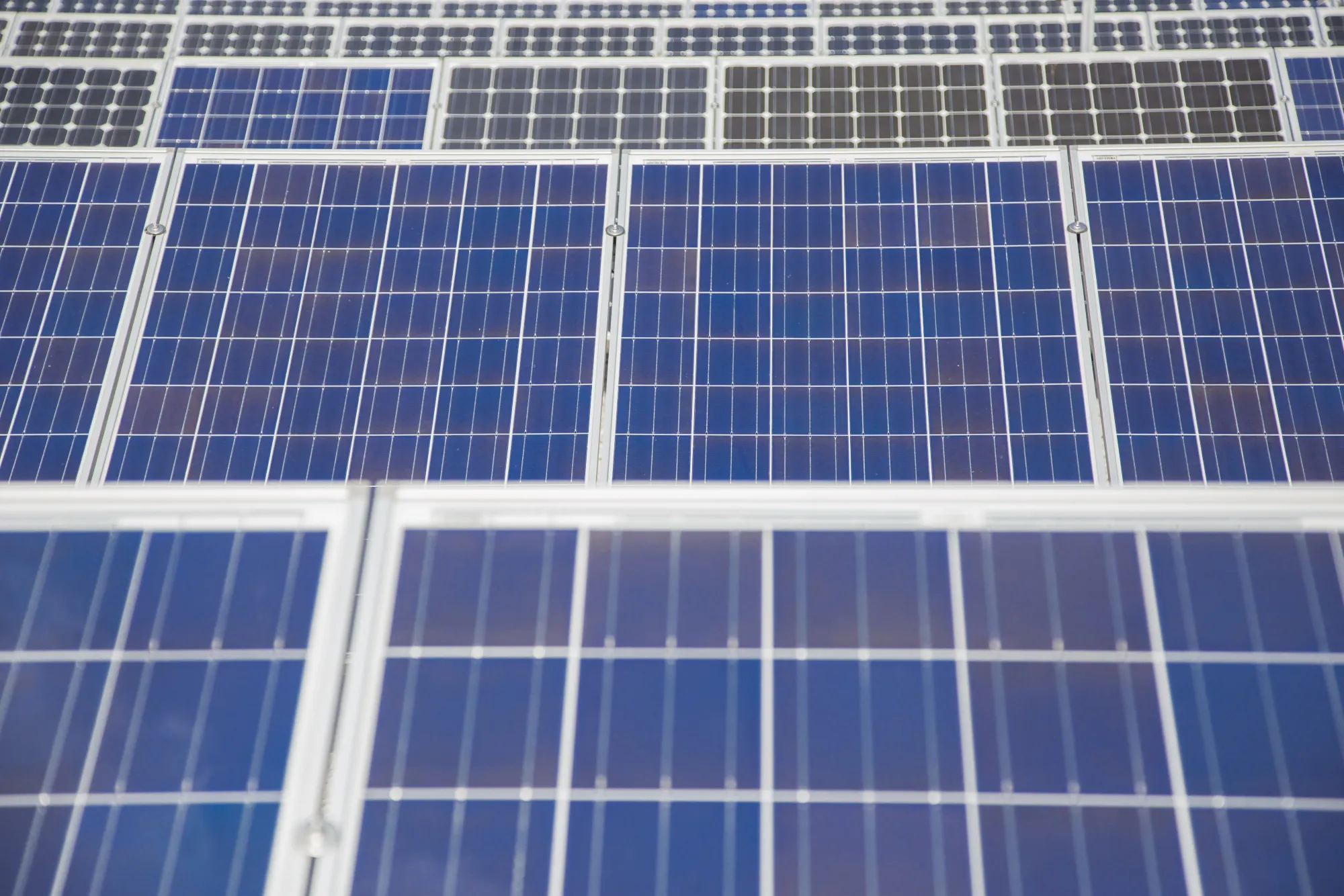 Photovoltaic modules sit on a rooftop at the Solarworld AG factory in Freiberg, Germany.