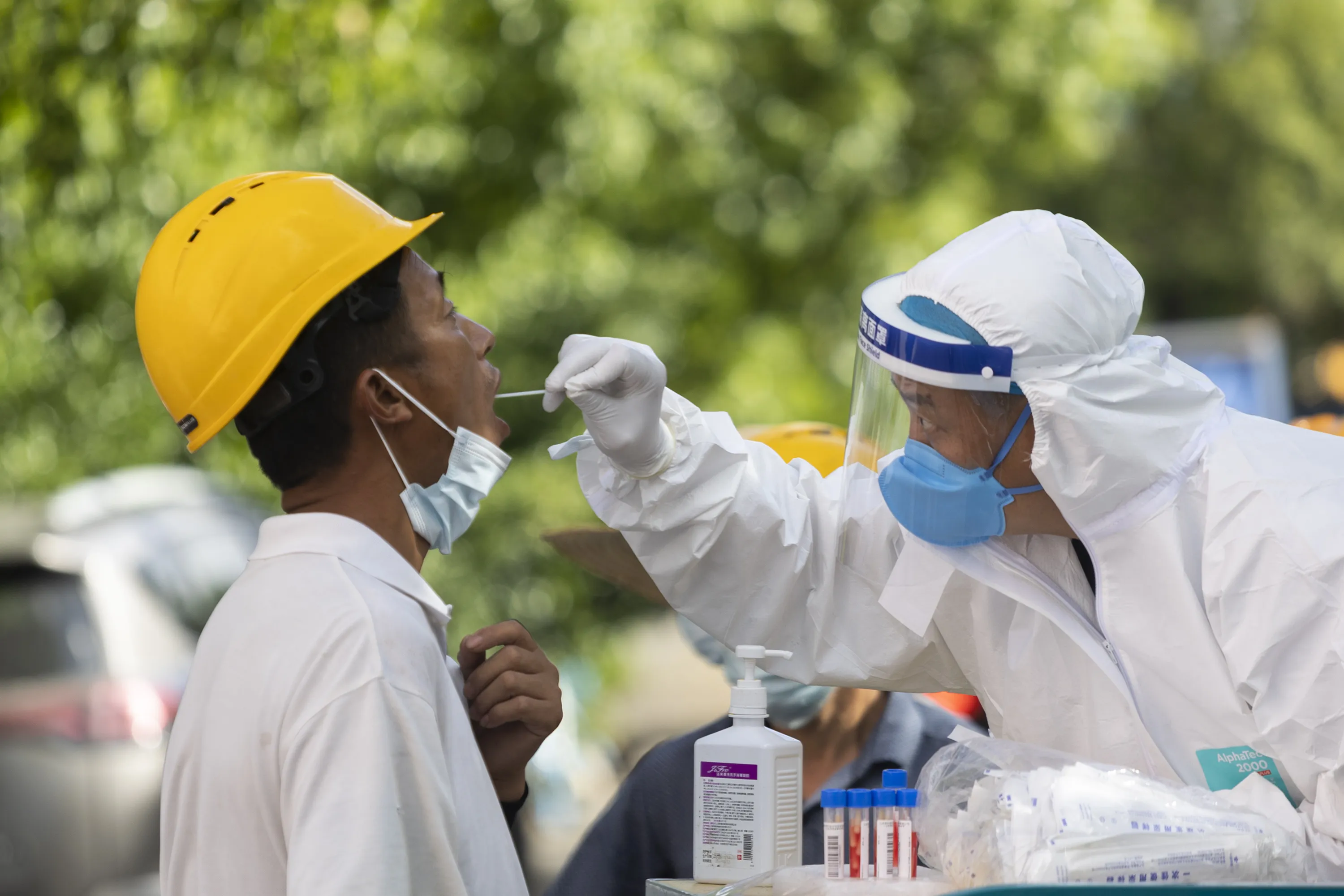 A worker is tested for Covid-19 in Shanghai on July 2.