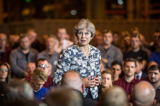 May Tells U.K.'s Leave-Voting Heartlands They Need a Soft Brexit