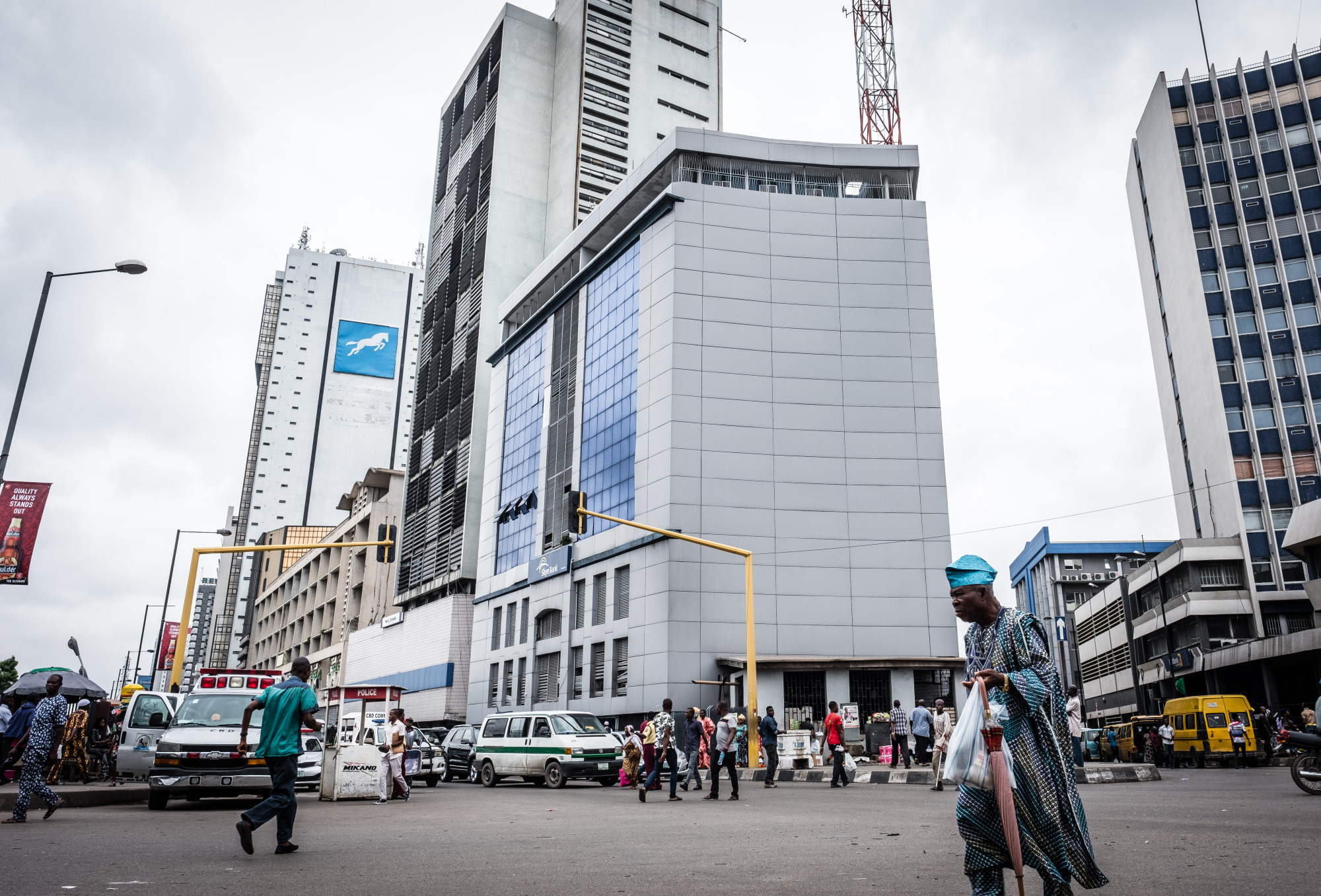 Pedestrians pass city office buildings in Lagos.