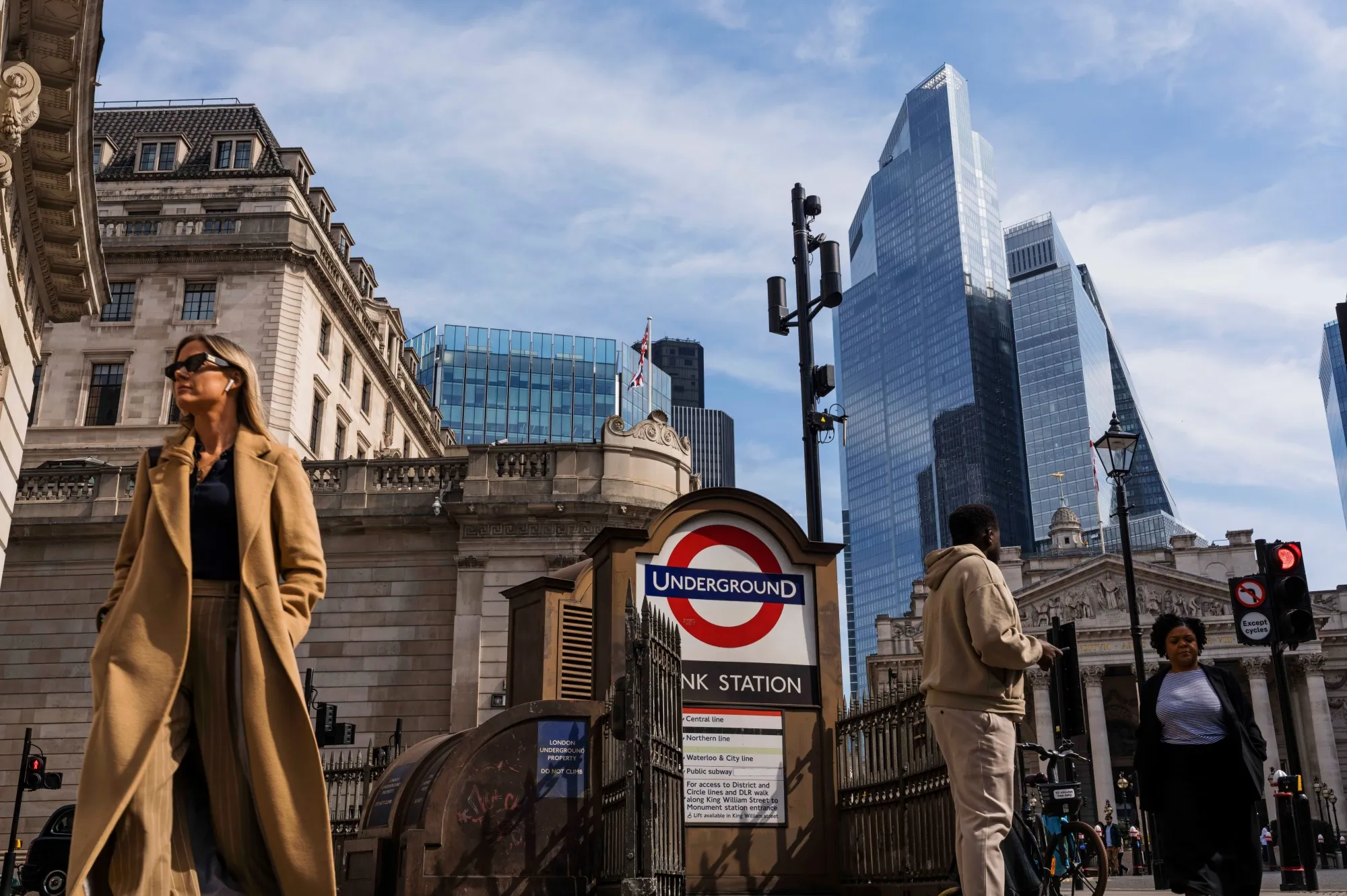 Workers pass Bank London Underground station in the City of London, UK, in April, 2025.