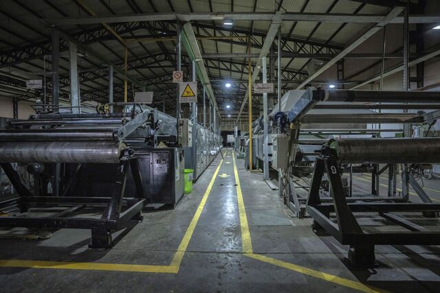 Machines idle on the production floor of the Barpla SA textile factory.