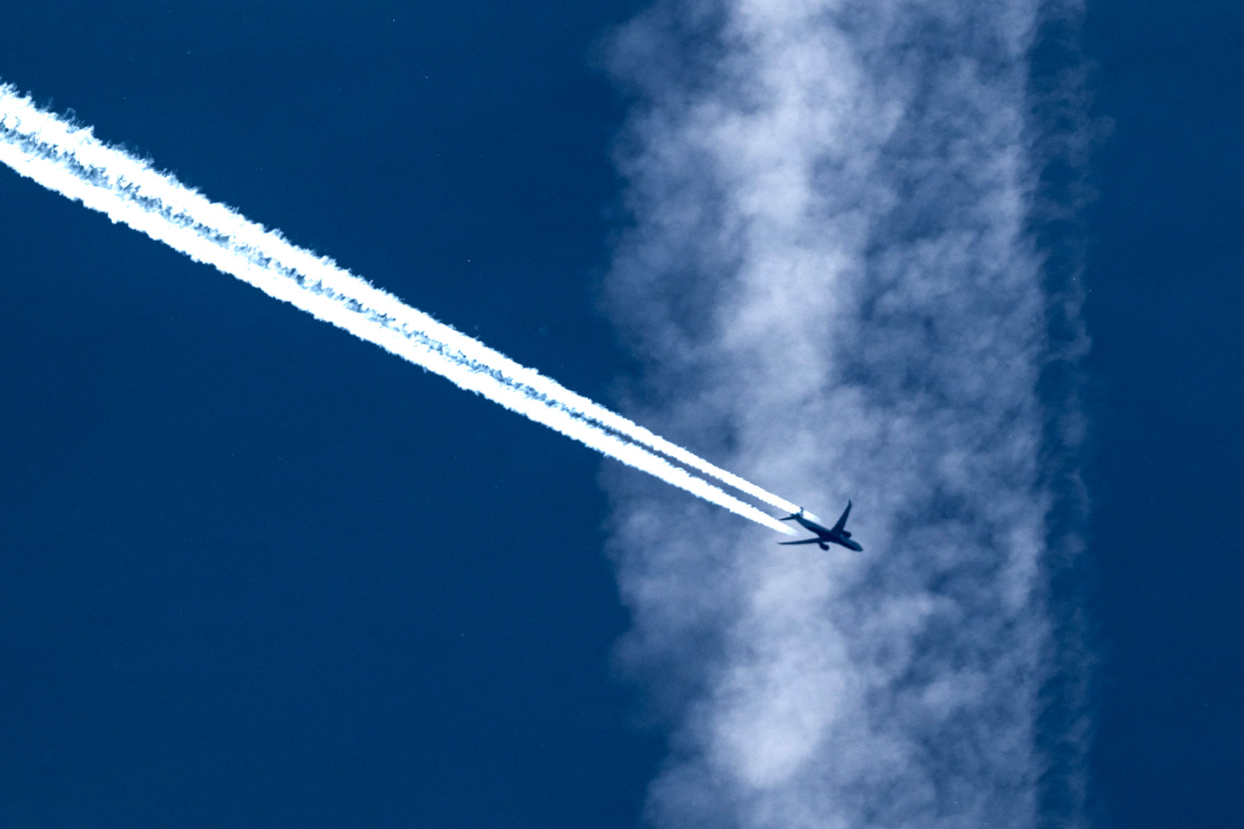 Contrails are composed of frozen water vapor attached to engine exhaust particles. Photographer: Olivier Chassignole/AFP/Getty Images