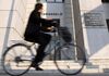 A man cycles past the Dai-ichi Mutual Life Insurance Co. headquarters in Tokyo, Japan, on Friday, March 19, 2010. Dai-ichi Mutual Life Insurance Co.'s initial public offering, the biggest in Japan since 1998, will value the company's shares right between its two largest competitors.