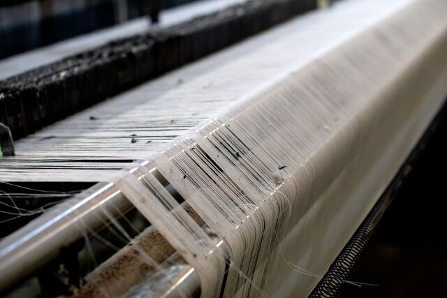 Abandoned threads on textile machinery at the non-operational Al Karim Weaving factory in Karachi, Pakistan