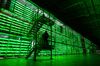 An armed guard patrols in front of illuminated mining rigs mounted inside racks at the BitRiver Rus LLC cryptocurrency mining farm in Bratsk, Russia, on Friday, Nov. 8, 2019. Bitriver, the largest data center in the former Soviet Union, was opened just a year ago, but has already won clients from all over the world, including the U.S., Japan and China. Most of them mine bitcoins.