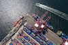 A tug boat sails past docked container ships in the Busan Port Terminal (BPT) at the Port of Busan in this aerial photograph taken in Busan, South Korea, on Tuesday, July 30, 2019. A trade dispute between South Korea and Japan is threatening to spiral out of control, and both governments want the White House on their side.