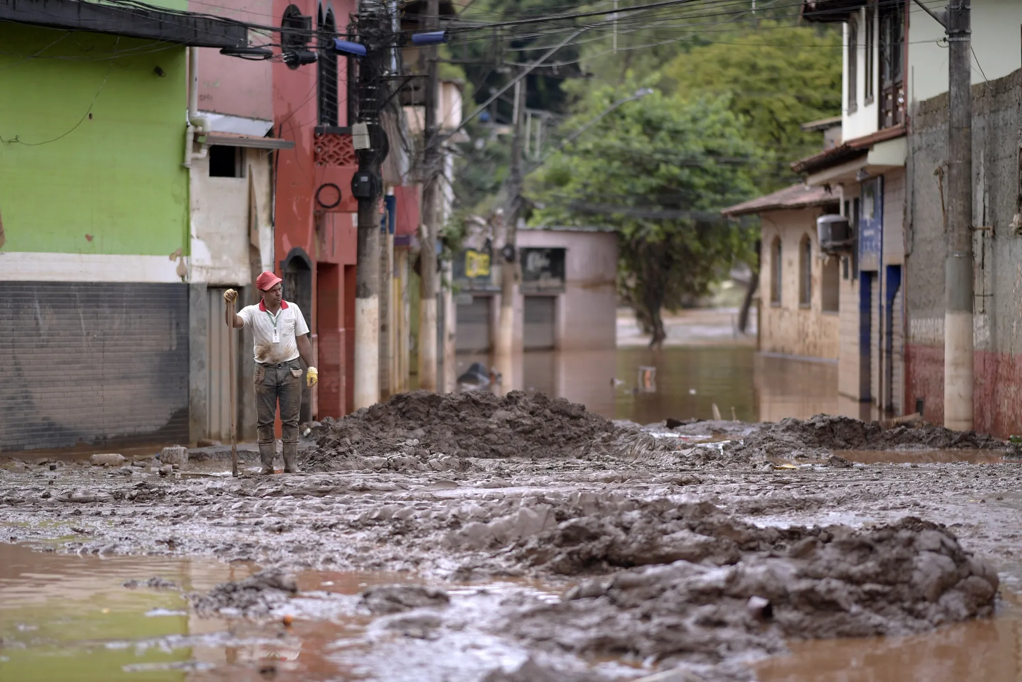 A man cleans a street after a flood in Mina Gerais state, Brazil, on Jan. 11.