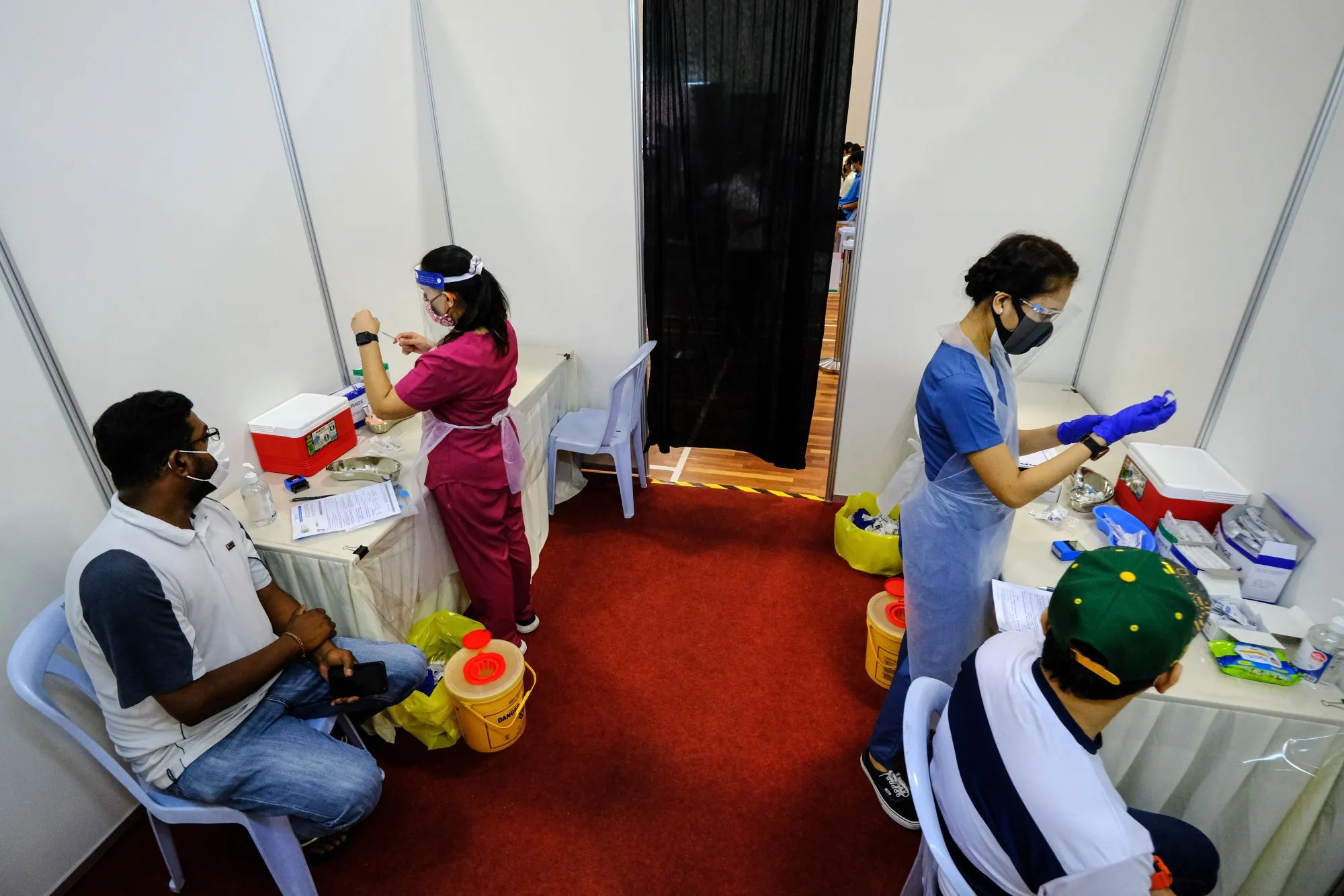 Health workers prepare doses of Covid-19 vaccine for sailors and port workers in Port Klang, Malaysia, on June 25.