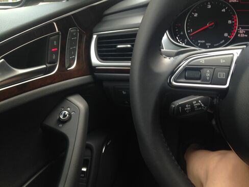 The interior includes buttons that wrap around the front of the cabin, rounding the corners as they blend into the doors of the car.