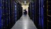An employee fixes part of a web server inside the Facebook Inc. Prineville Data Center in Prineville, Oregon, U.S., on Monday, April 28, 2014. The Facebook Prineville Data Center features leading energy-efficient technology, including features such as rainwater reclamation, a solar energy installation for providing electricity to the office areas and reuse of heat created by the servers to heat office space.