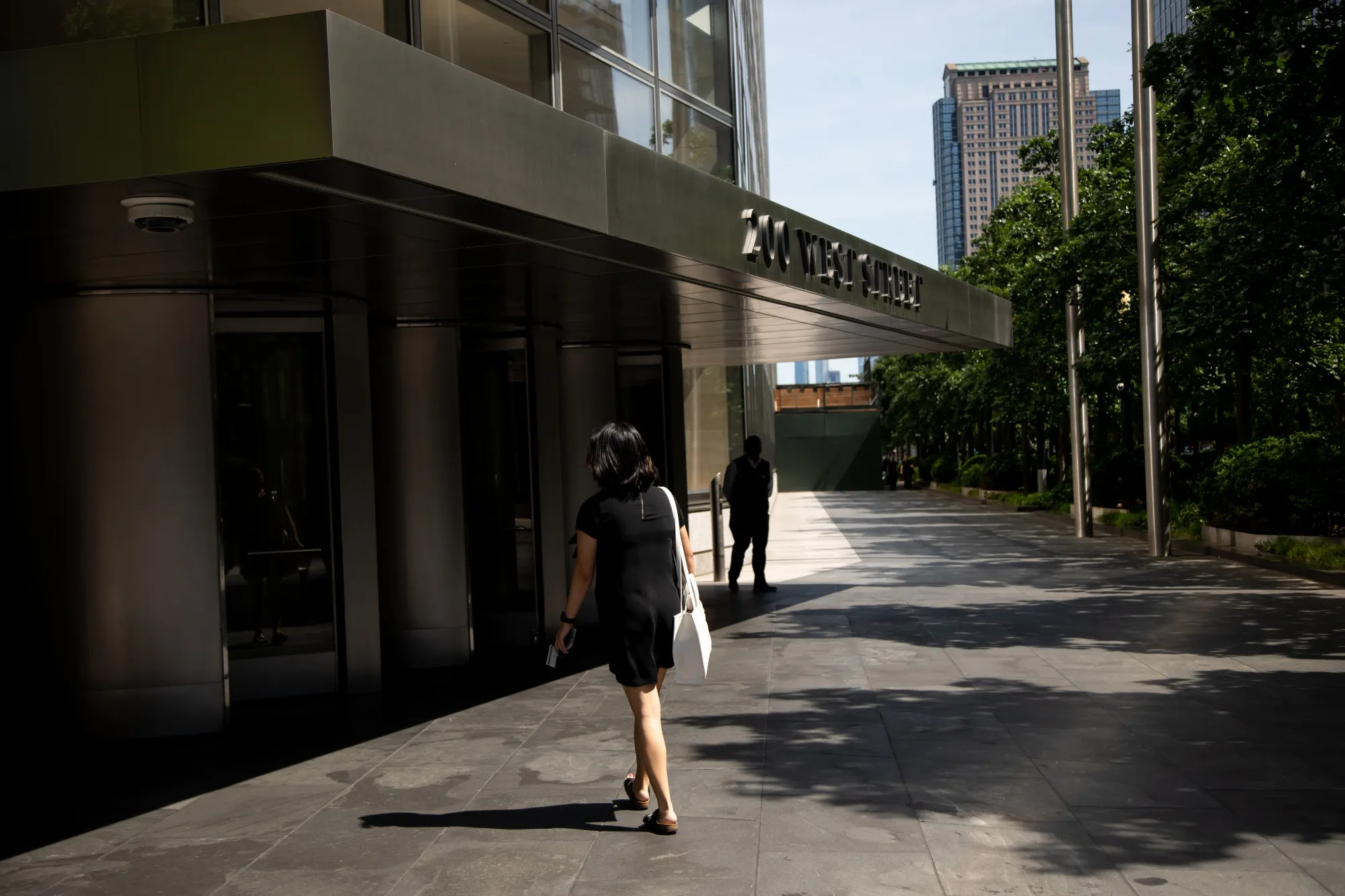 A worker arrives at Goldman Sachs headquarters in New York in June.&nbsp;