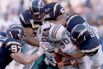 Bernie Parmalee of the Miami Dolphins (C) is gang-