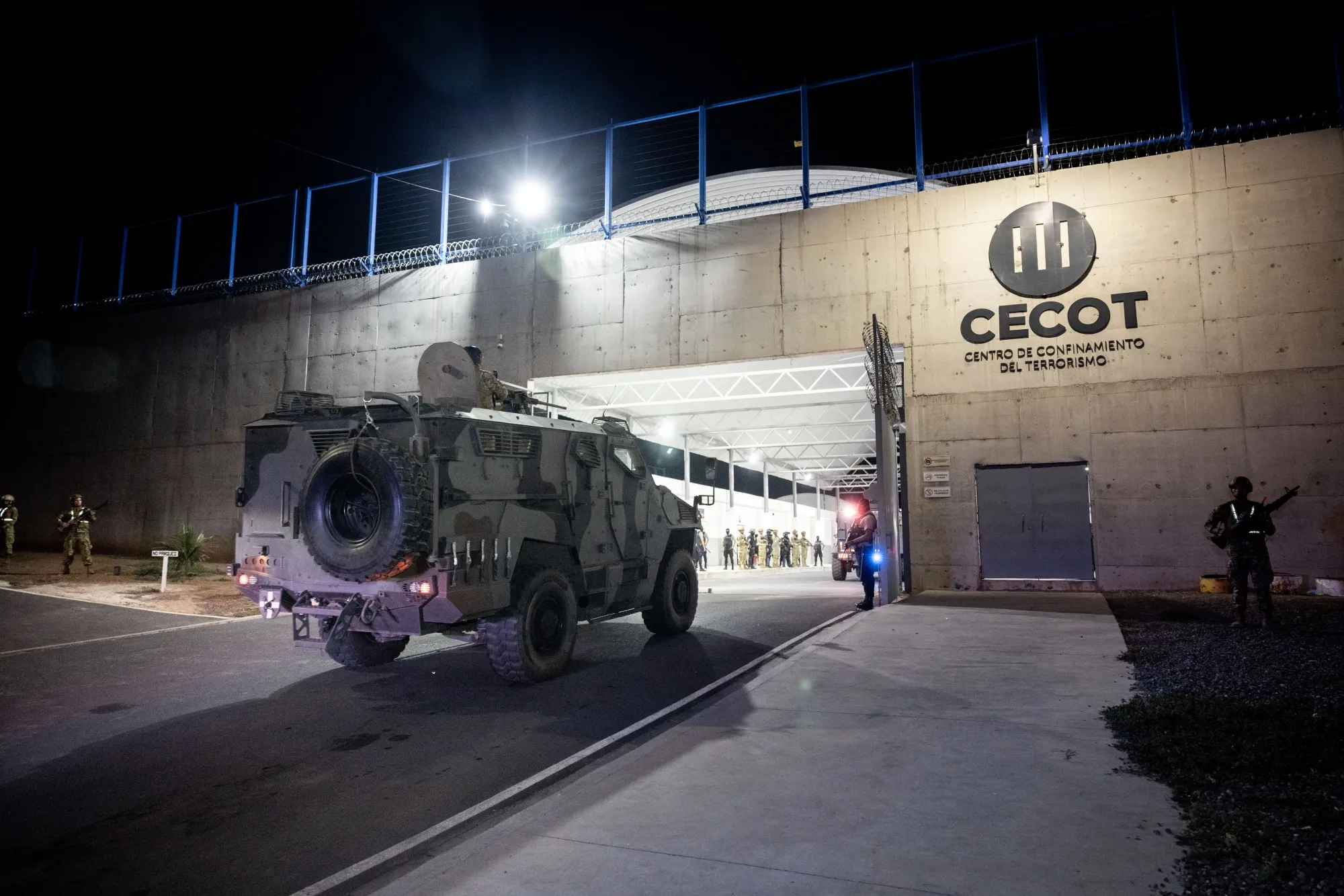 In this photo released by the El Salvador Presidency,&nbsp;members of the Salvadoran army stand guard at the Terrorism Containment Center maximum security prison with deported individuals from the US, on March 16.
