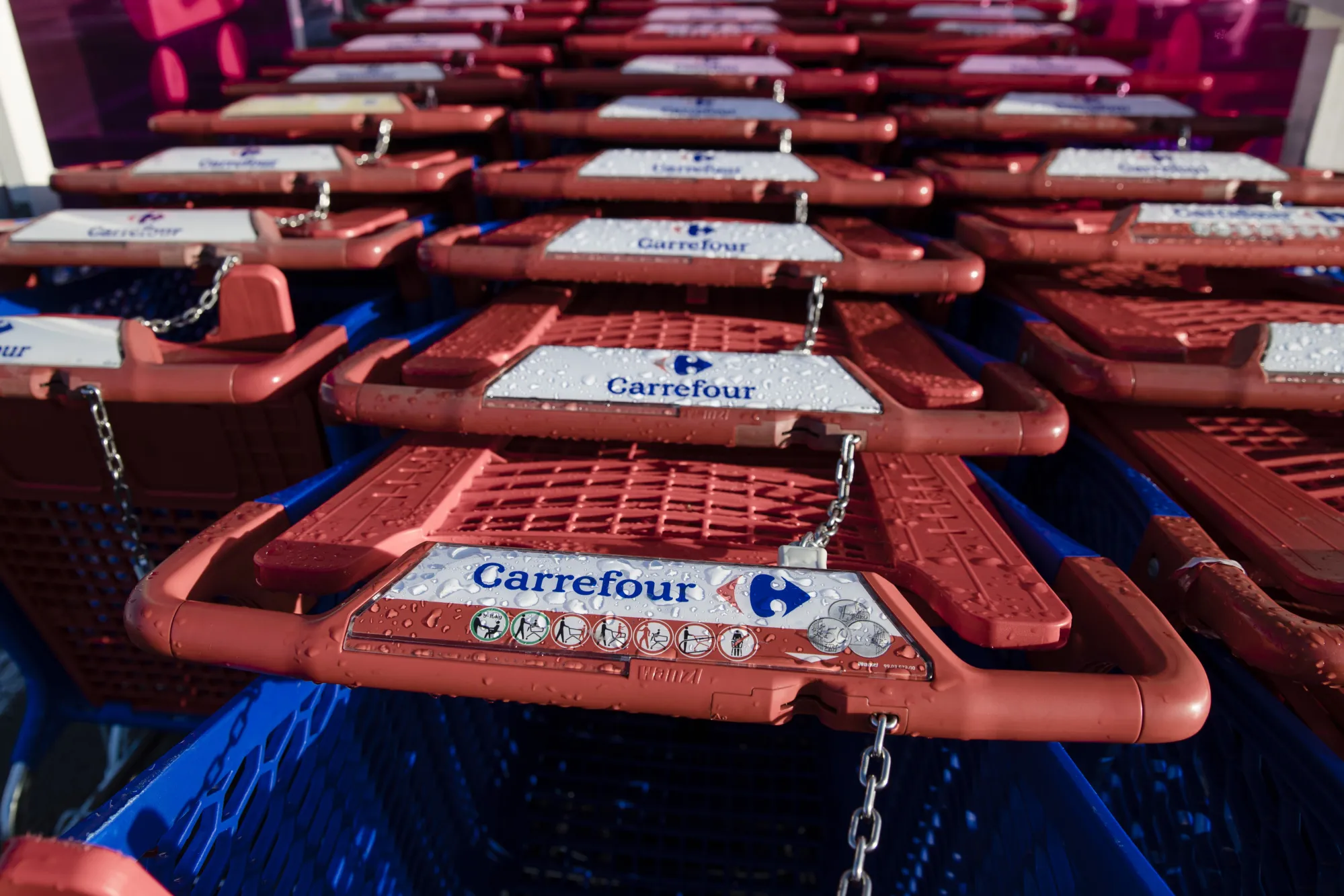 Locked shopping carts stand in a customer collection bay outside a Carrefour SA supermarket in the Rosny-sous-bois district of Paris, France, on Friday, Jan. 19, 2018.  Carrefour's sales bounced back over the holiday shopping season, giving Chief Executive Officer Alexandre Bompard a boost as he prepares his turnaround strategy.