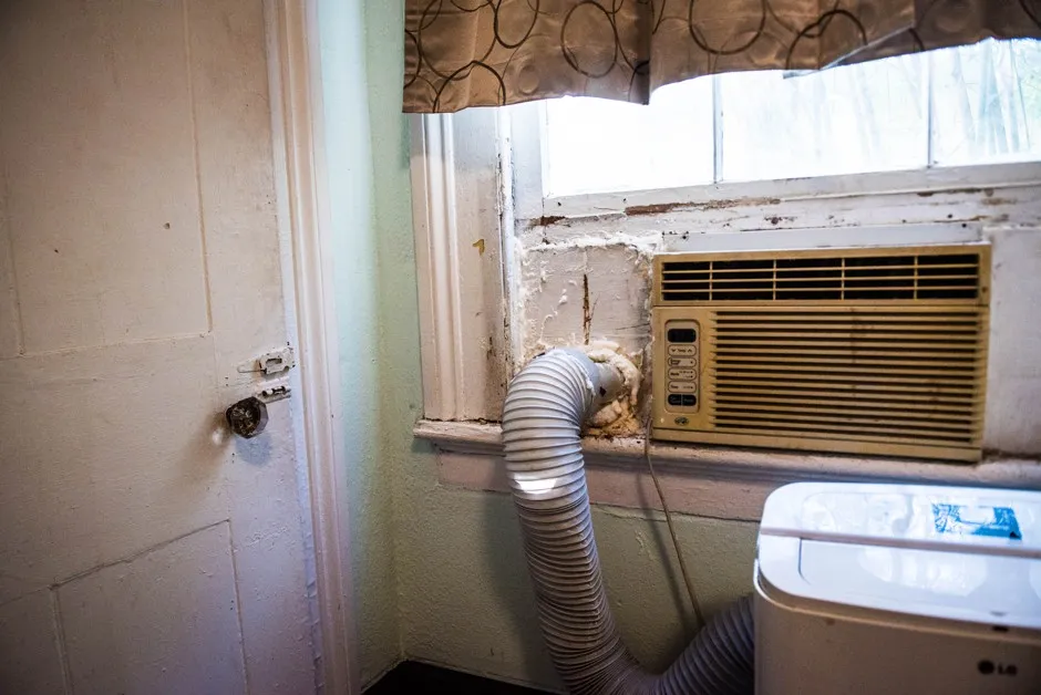 An A/C unit in a house in New Orleans. Gaps in windows and walls can cause air to leak out, and energy bills to rise.
