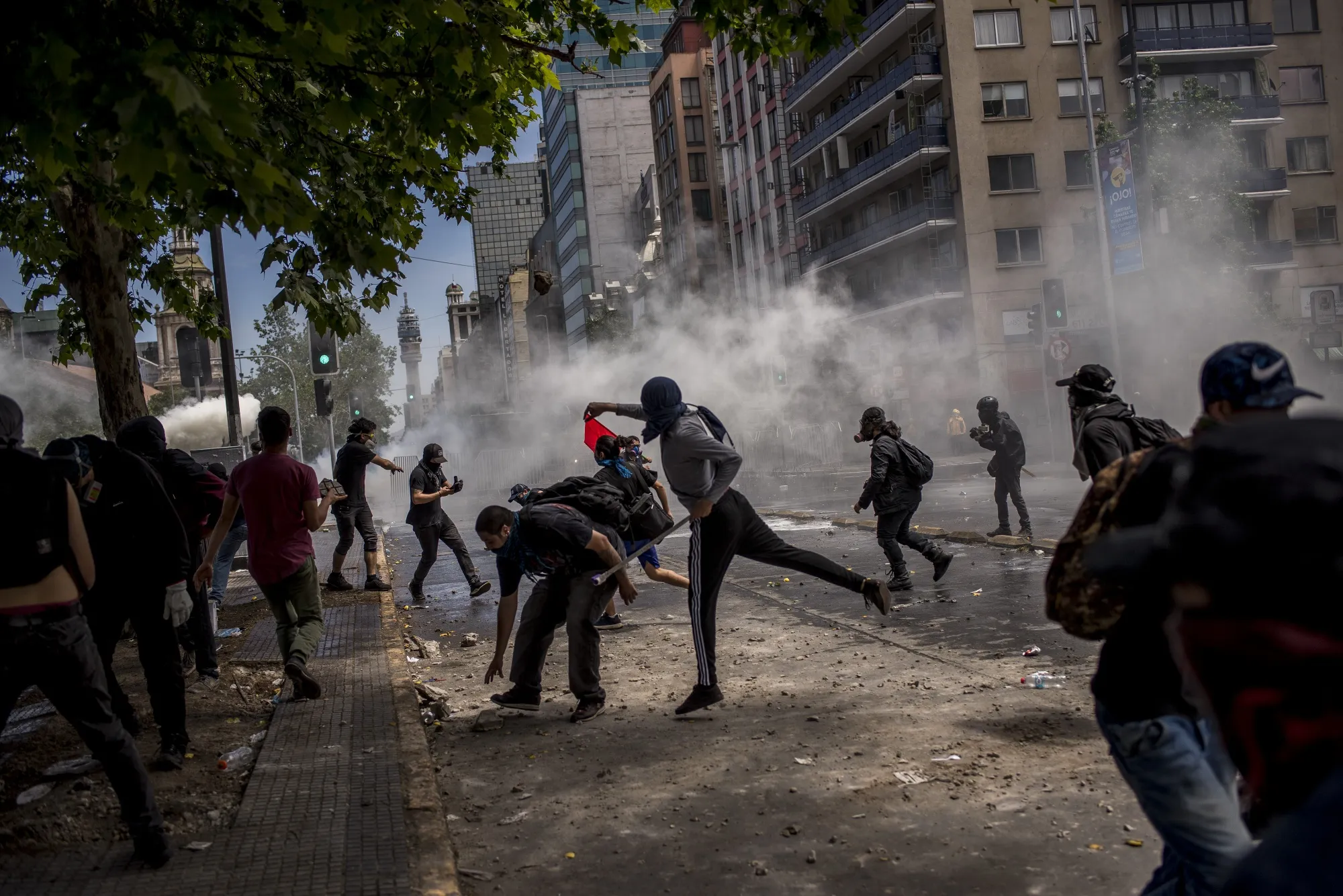 Demonstrators clash with riot police during a protest at Italy Plaza&nbsp;in Santiago, Chile, on Wednesday, Oct. 23, 2019.