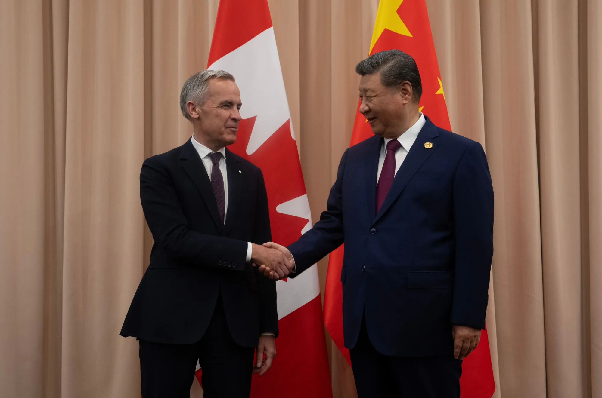 Canadian Prime Minister Mark Carney, left, and Chinese President Xi Jinping in October. Carney is returning to China today as foreign leaders flock to Beijing.