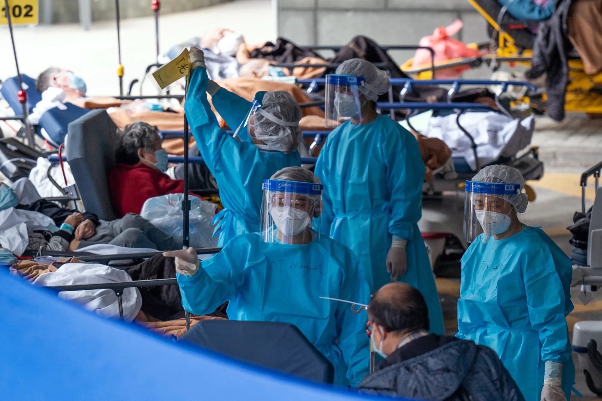 Healthcare workers attend to patients at a temporary triage area at the Caritas Medical Center hospital in Hong Kong, China, on&nbsp;Feb. 28.