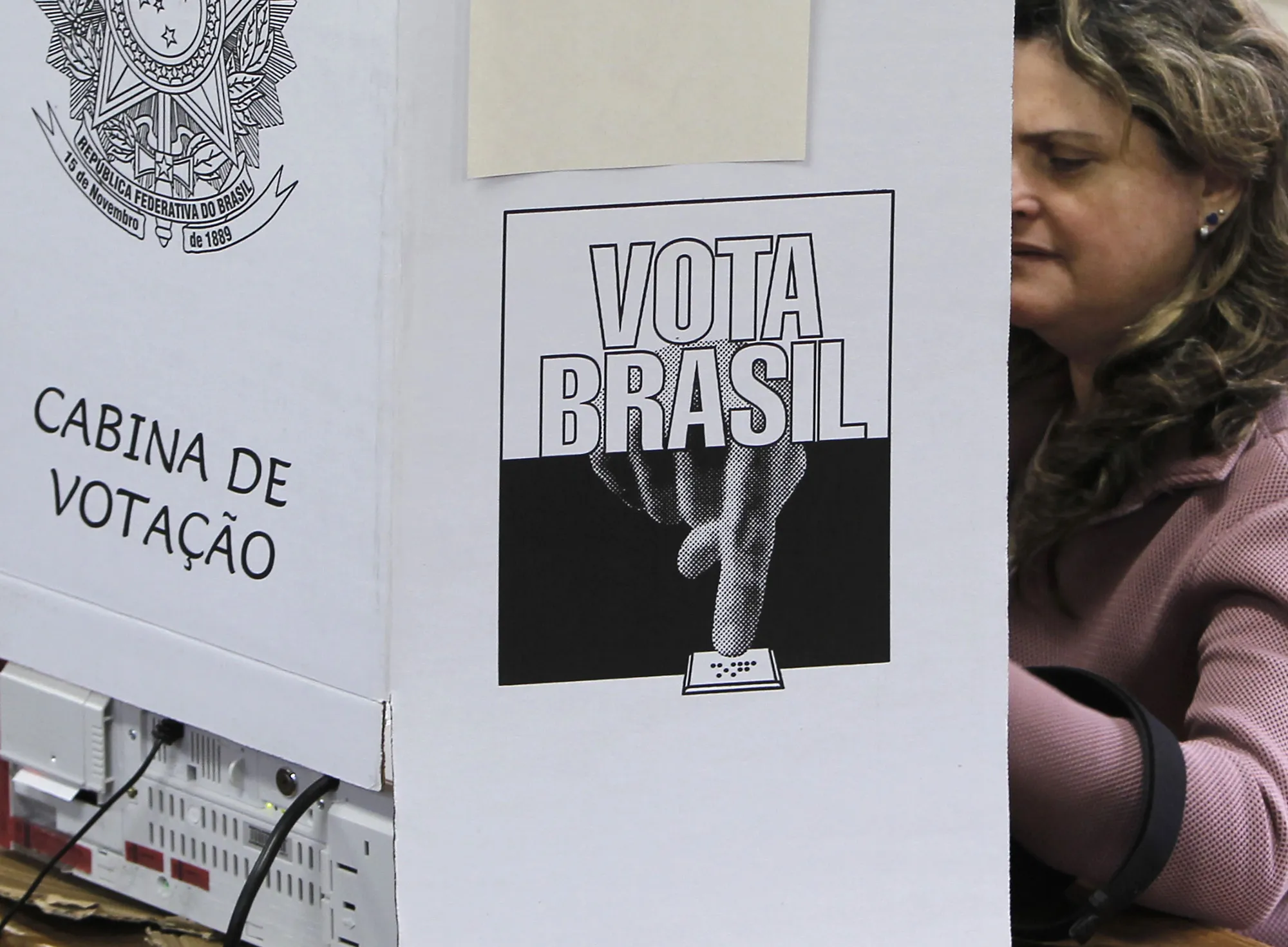 A woman leaves the polling booth after c