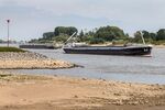 Half-loaded barges pass each other closely in low waters caused by drought on the Rhine River in Lobith, Netherlands, on&nbsp;July 30.