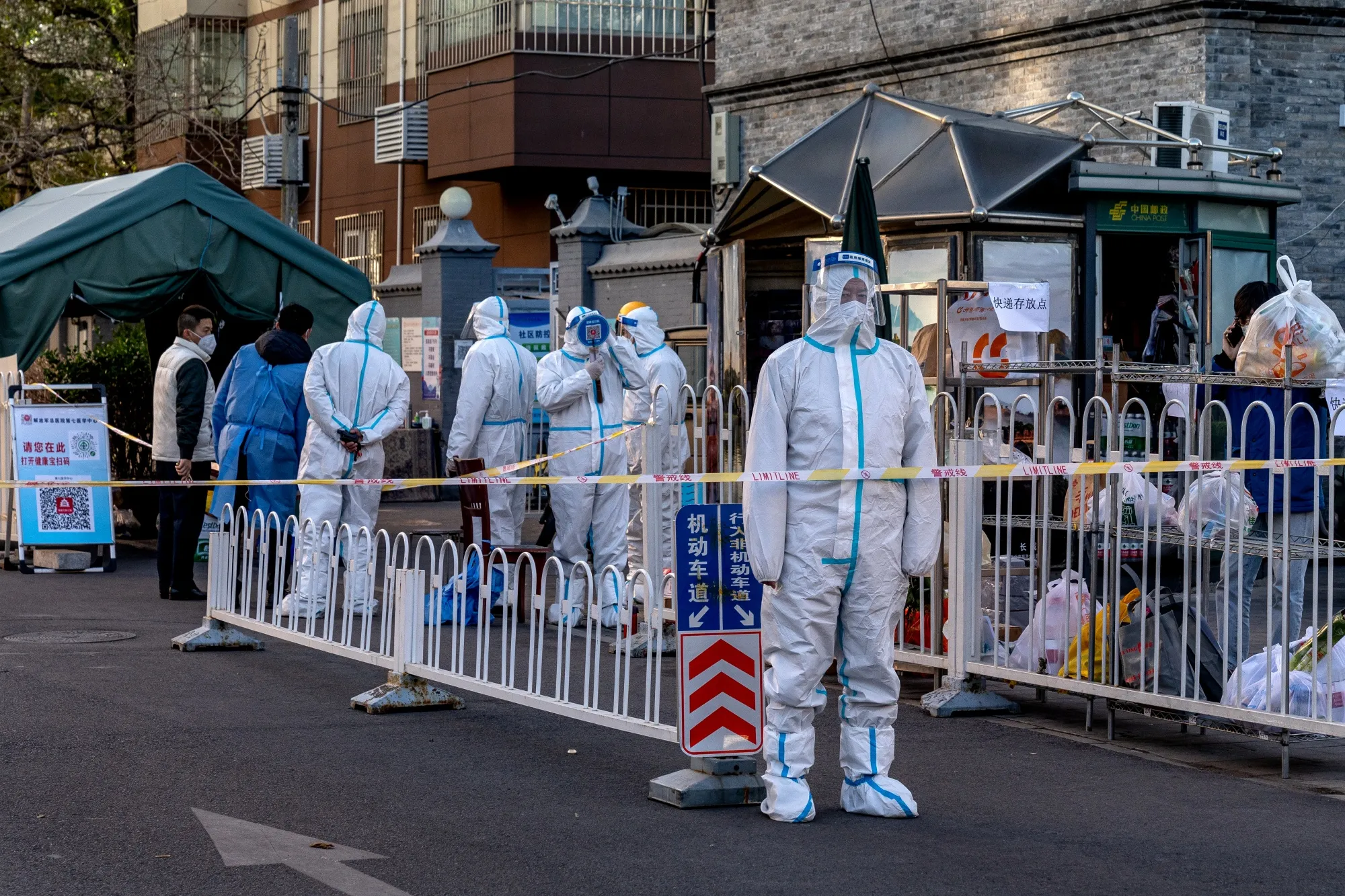 Workers in protective gear at a neighborhood placed under lockdown in Beijing, on Nov. 21.