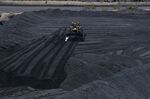 A bulldozer moves coal at a coal mine in Colombia.
