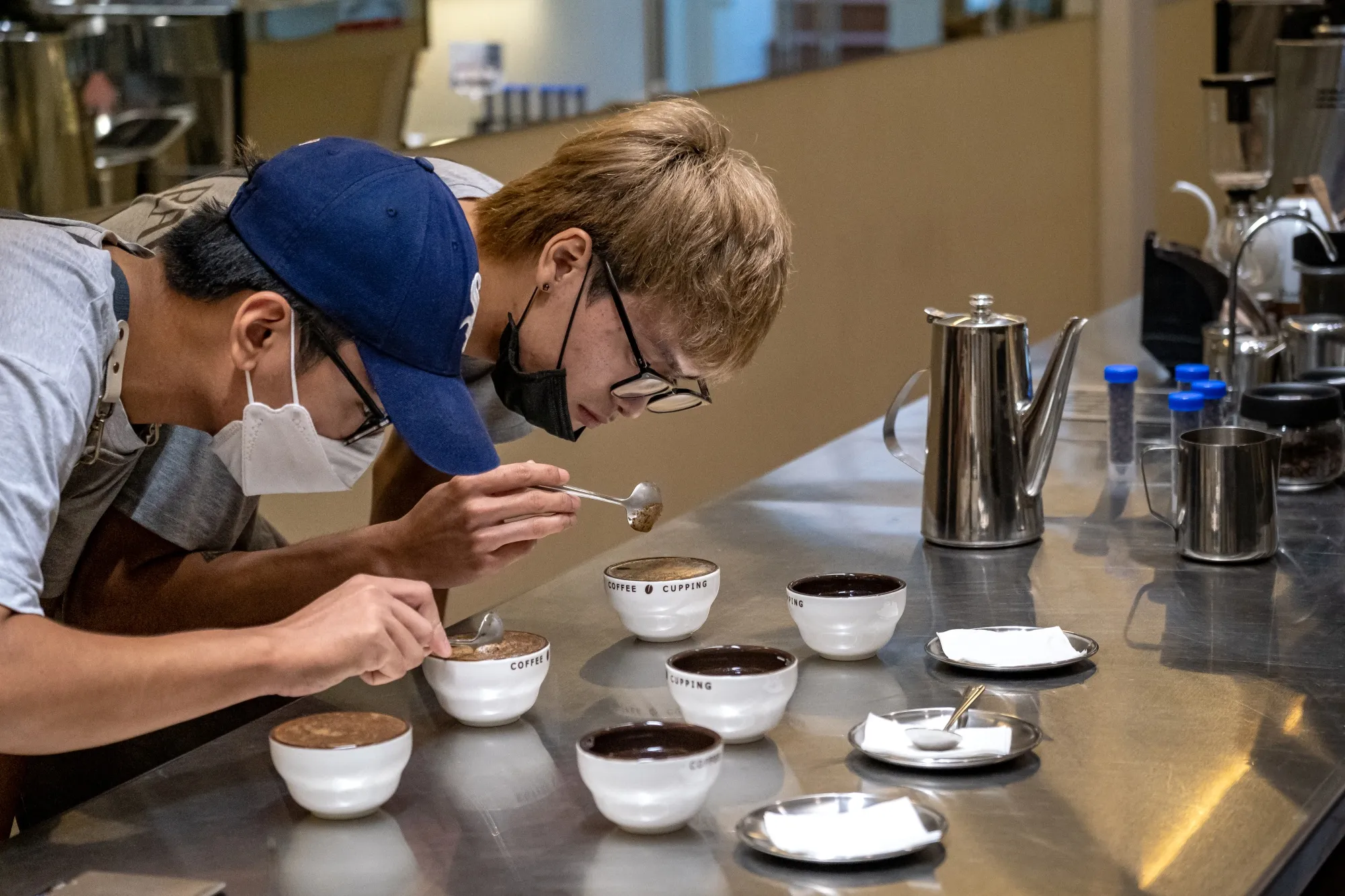 Baristas prepare cups of coffee.