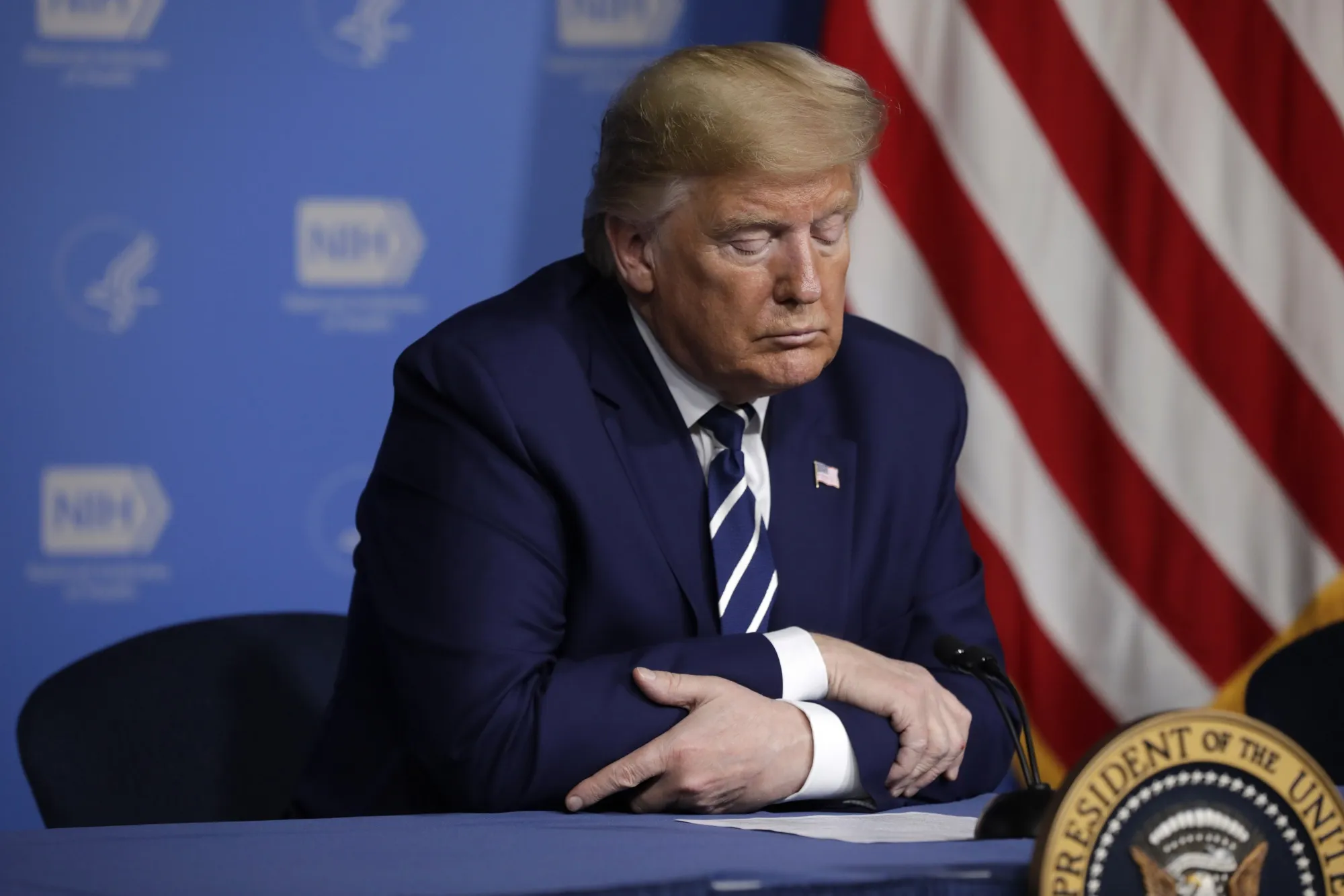 Donald Trump listens during a briefing at the National Institutes of Health Vaccine Research Center in Bethesda, Maryland on March 3.