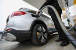 A driver refuels a hybrid plug-in SUV automobile in Sindelfingen, Germany. 