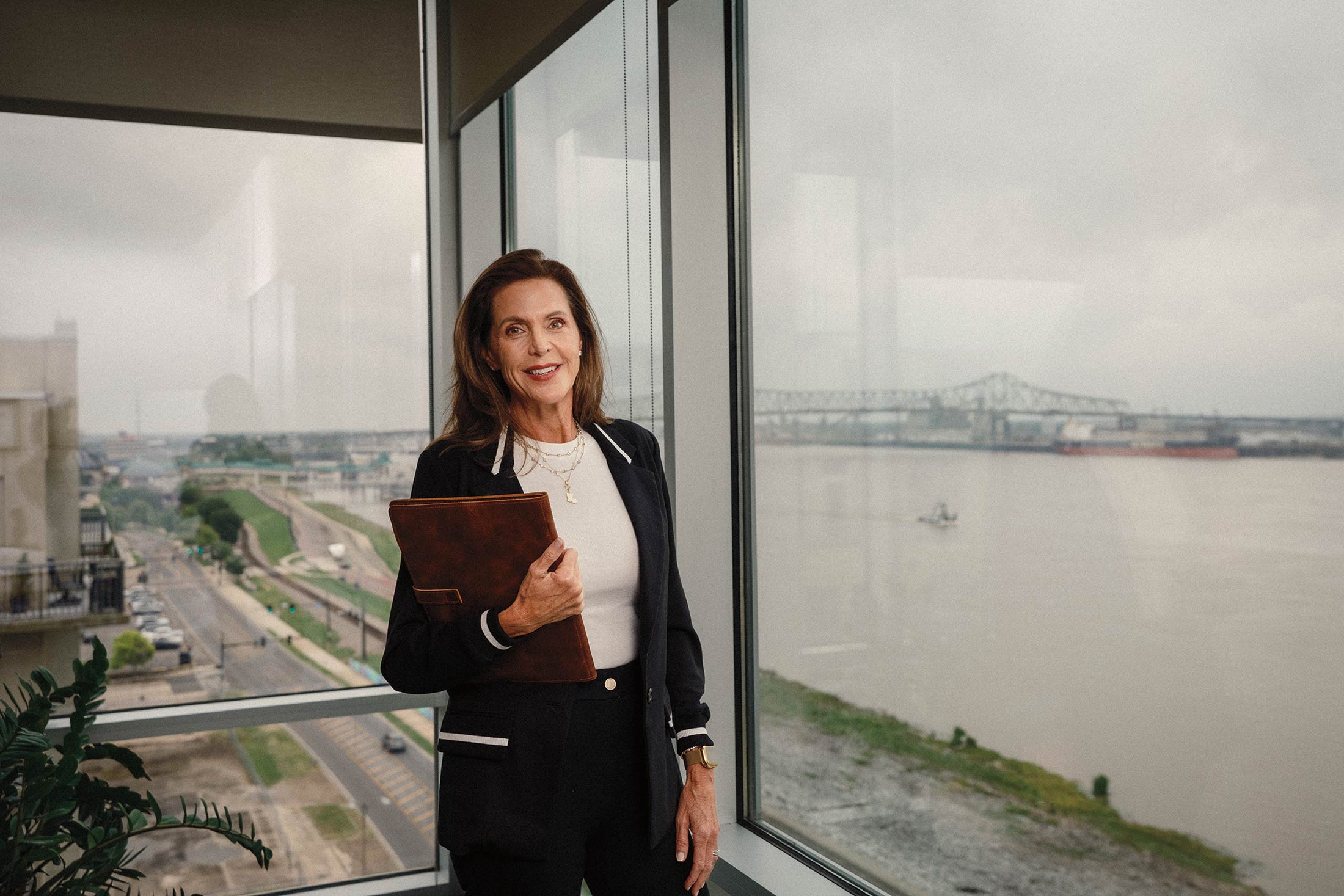 A portrait of Susan Bonnett Bourgeois, secretary of the Department of Louisiana Economic Development, stands in her office overlooking the Mississippi River in Baton Rouge.