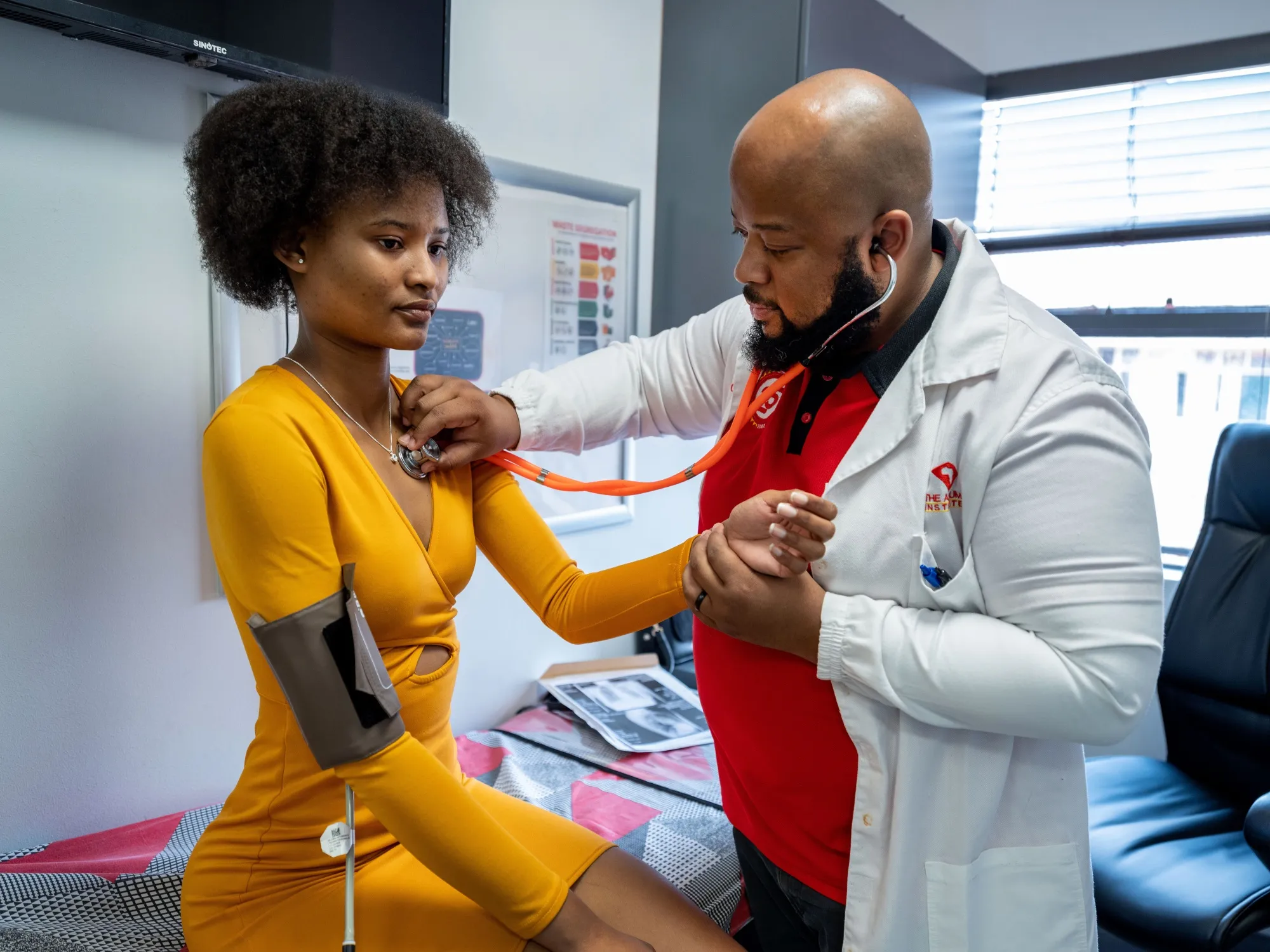 Thuto Pulane, a participant of the NC-009 pan-Phase 2 clinical trial at a check-up with Dr. William Brumskine after completing treatment.