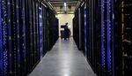 An employee fixes part of a web server inside the Facebook Inc. Prineville Data Center in Prineville, Oregon.