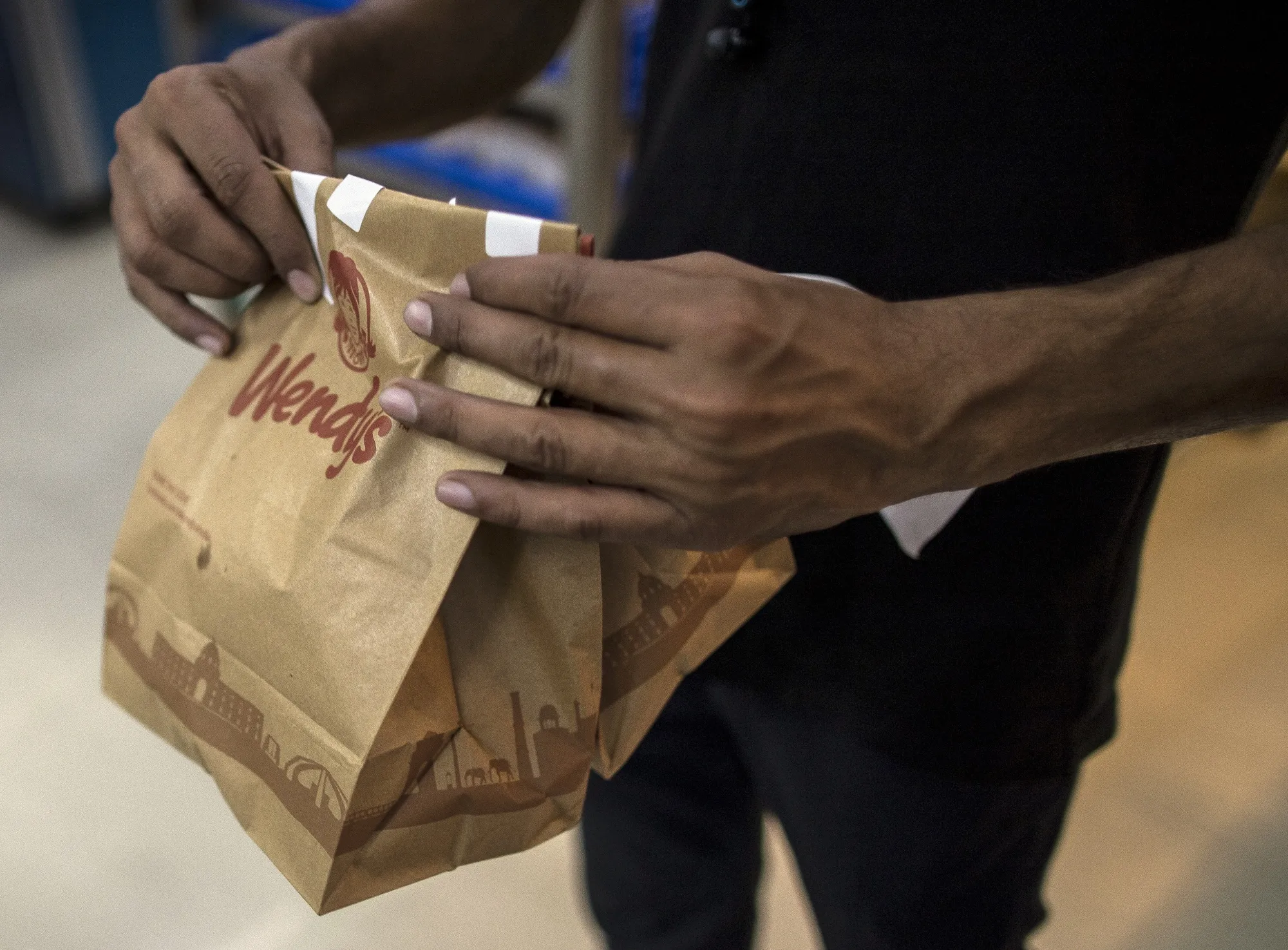 An employee holds a Wendy’s food order at a Rebel Foods Ltd. cloud kitchen in Noida, India, in 2021. 