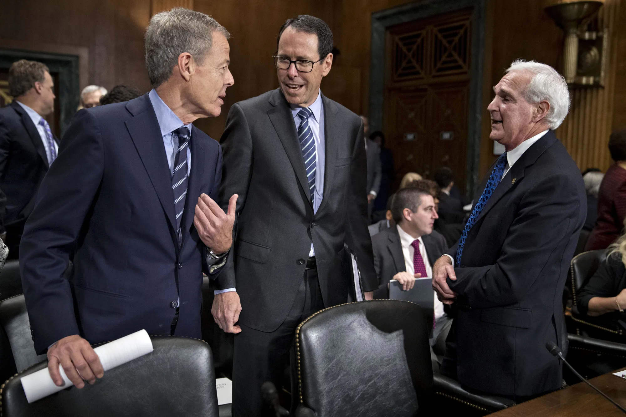 Jeffrey&nbsp;Bewkes, chairman and chief executive officer of Time Warner Inc., from left, speaks with Randall Stephenson, chairman and chief executive officer of AT&amp;T Inc., and Gene Kimmelman, president and chief executive officer of Public Knowledge, before a Senate Judiciary Subcommittee hearing in 2016.