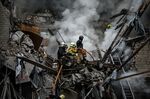 Firefighters extinguish a fire after an apartment was hit by a missile strike in Kharkiv, Ukraine.&nbsp;