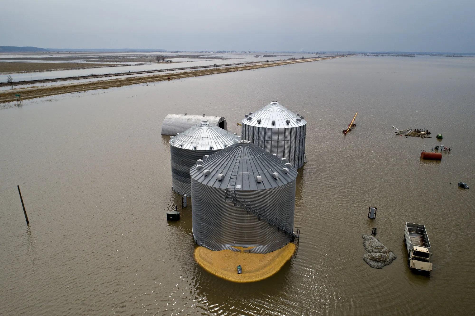 Floodwaters surround corn sitting under a collapsed grain bin in this aerial photograph over Thurman, Iowa,&nbsp;on&nbsp;March 23, 2019. T