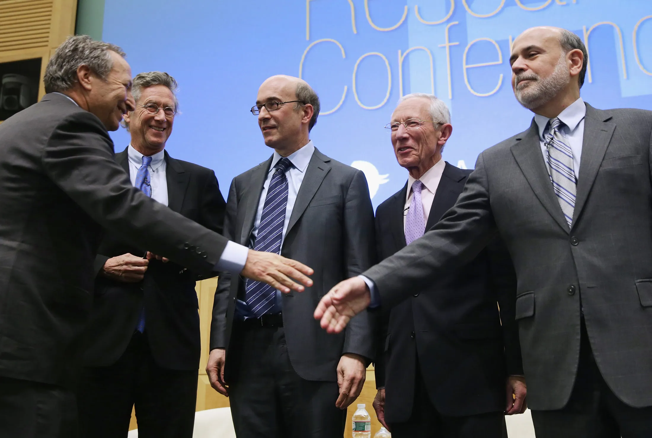 Lawrence Summers shakes hands with Ben Bernanke at the IMF headquarters in Washington on Nov. 8, 2013.
