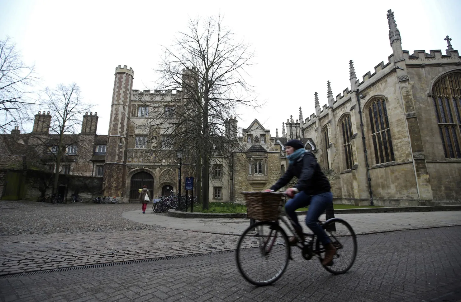 A cyclist rides a bicycle past a University of Cambridge building&nbsp;in Cambridge.