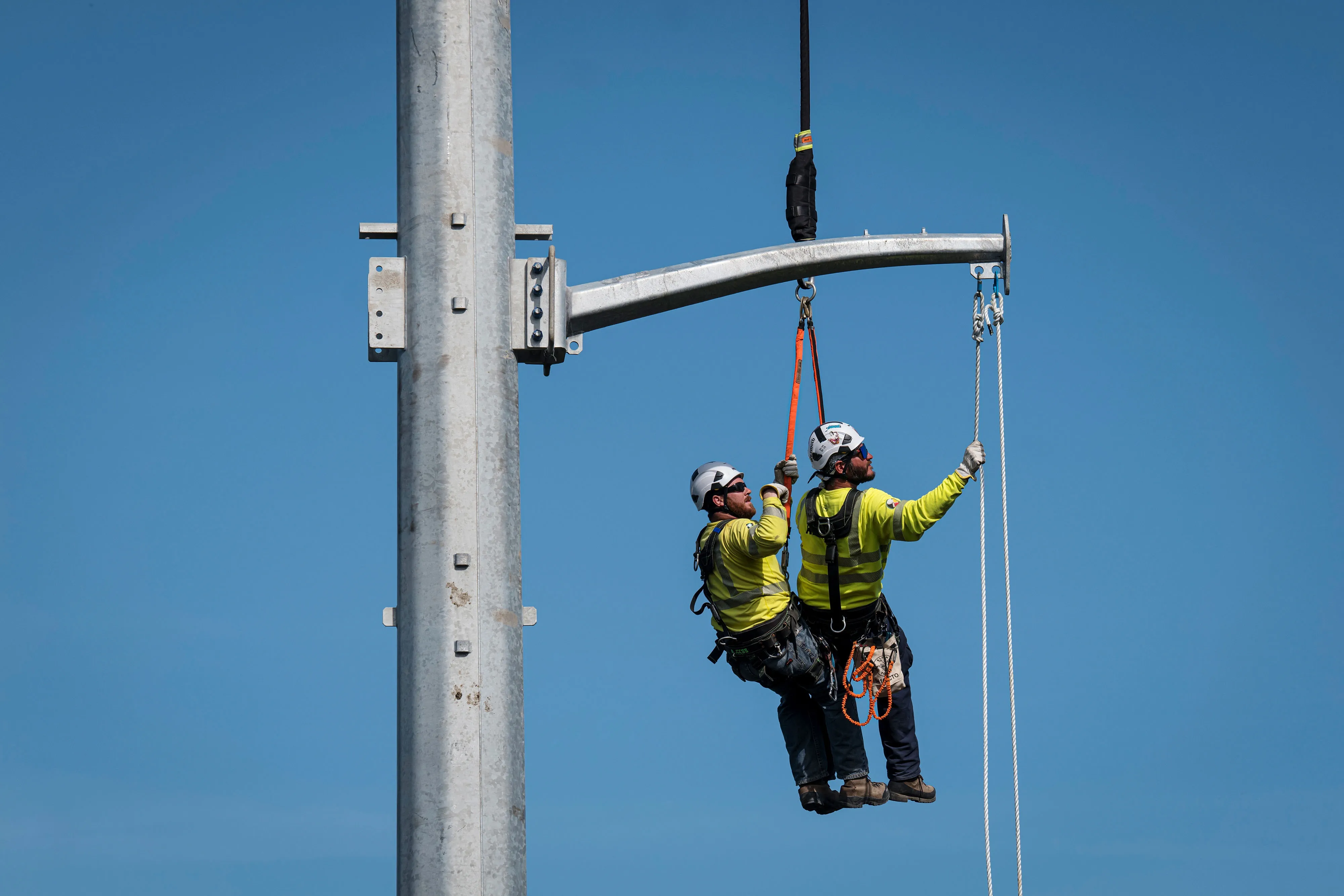 Contractors working for PG&E install steel power poles in St. Helena, California, on April 21.