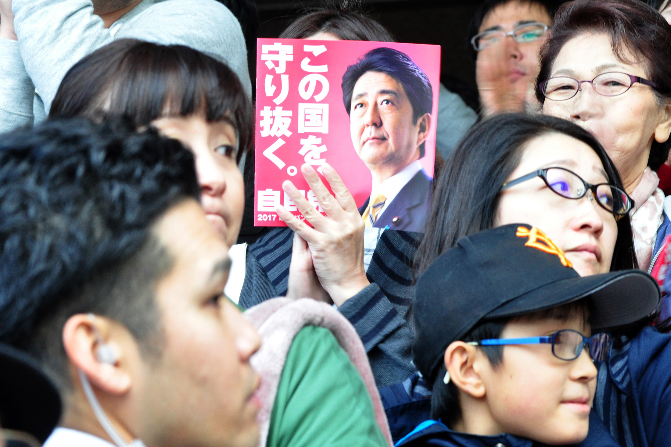 An attendee holds a pamphlet during a Shinzo Abe election campaign rally in Sapporo, Hokkaido.
