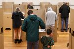 Voters cast ballots at a polling station during a federal election in Sydney on May 21.