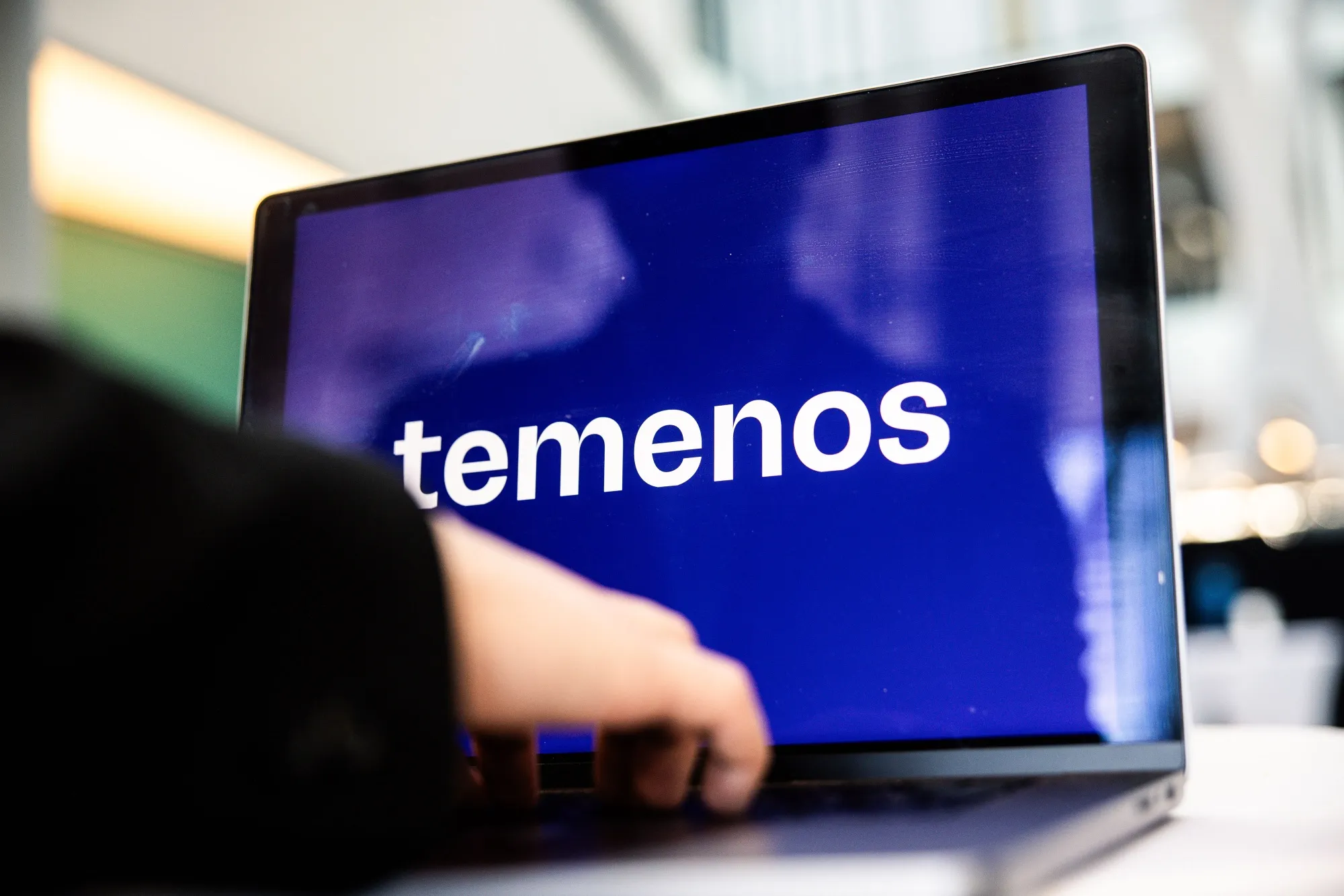 A Temenos AG logo on a laptop.