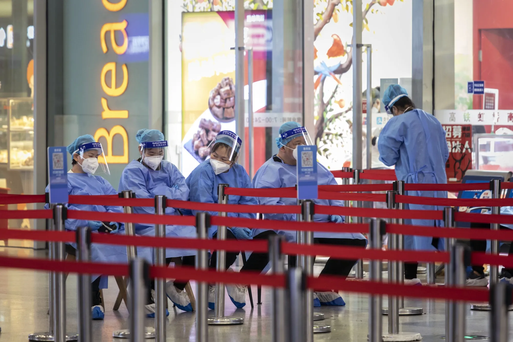 Workers in protective gear at the Shanghai Hongqiao Railway Station in Shanghai.
