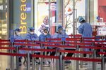 Workers in protective gear at the Shanghai Hongqiao Railway Station in Shanghai.