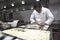 A chef prepares pizza pockets.
