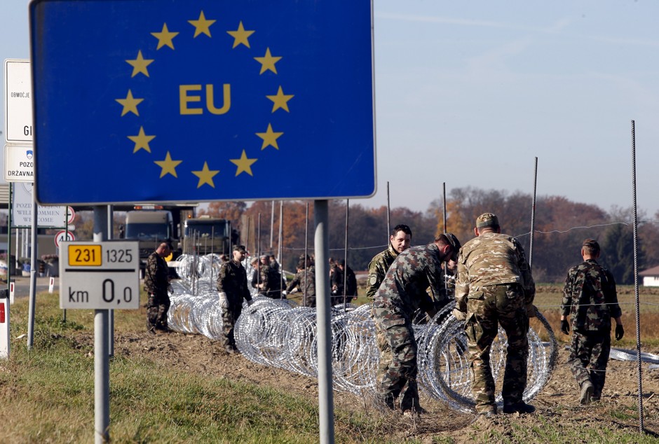 Soldiers set up a wire fence in Slovenia, on the Schengen Area's external border.