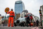 A construction worker halts traffic in the City of London in December 2021.&nbsp;