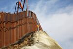 A construction crew works as new sections of the U.S.-Mexico border barrier are installed replacing smaller fences on January 11, 2019.
